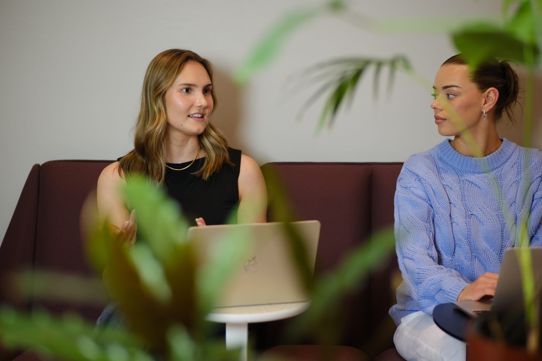 Two specialists planning a marketing budget at a laptop